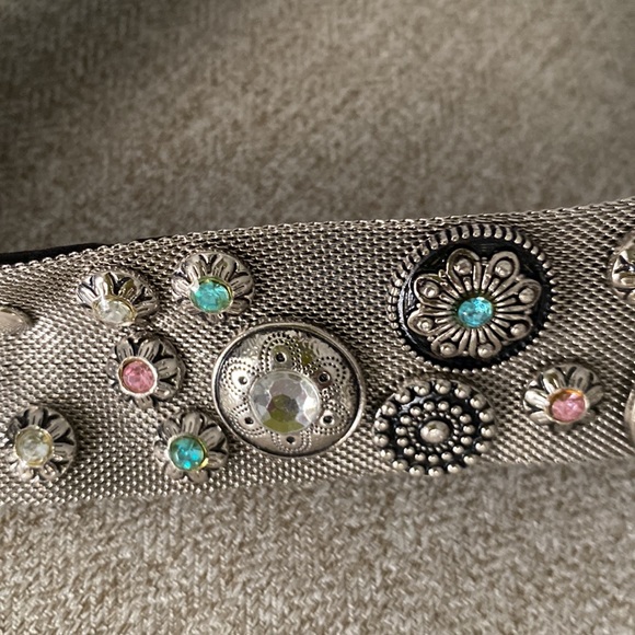 Western belt with multi colored crystals on a silver mesh belt.